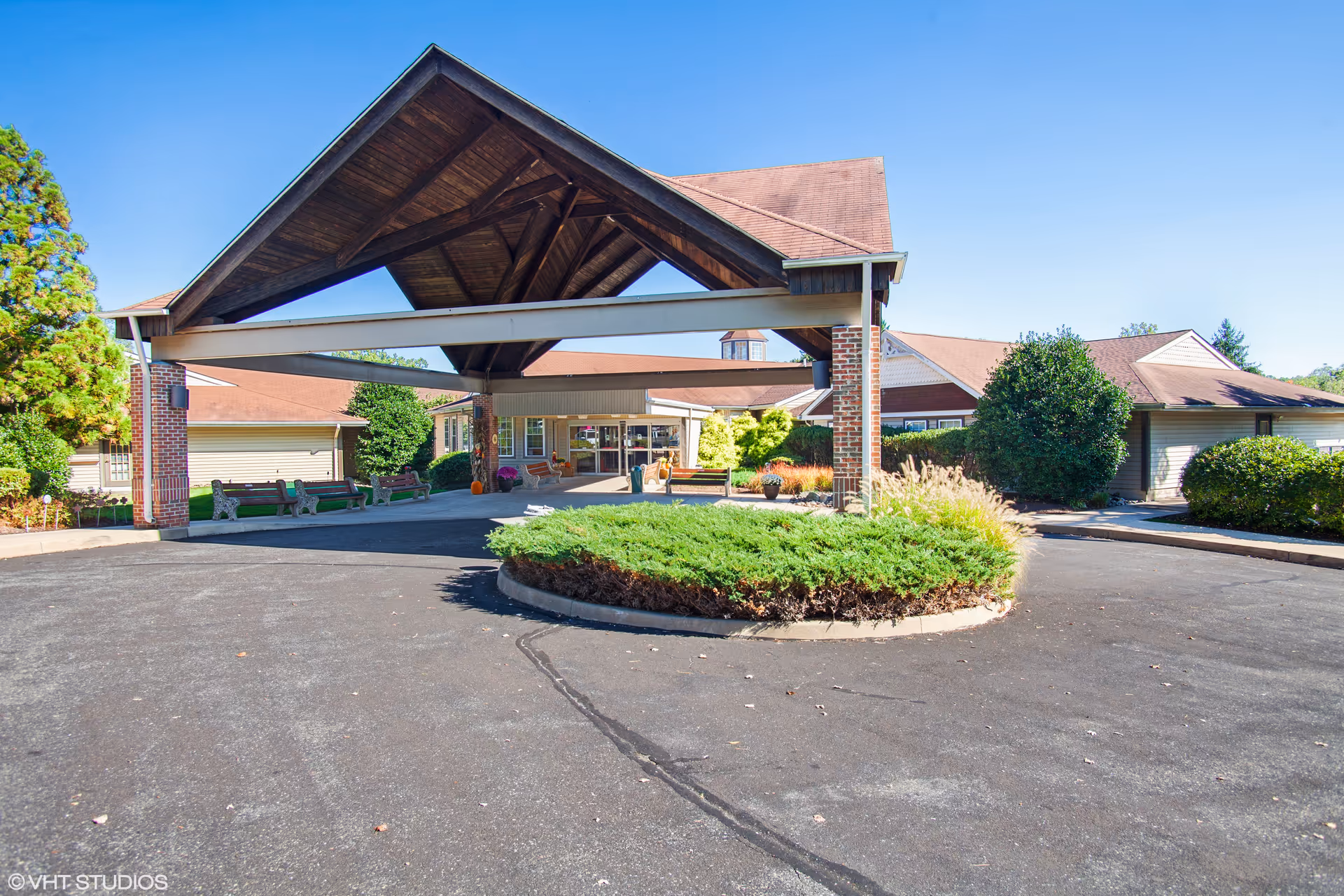 Exterior view of Truewood by Merrill Glen Riddle entrance with a large wooden peaked canopy.