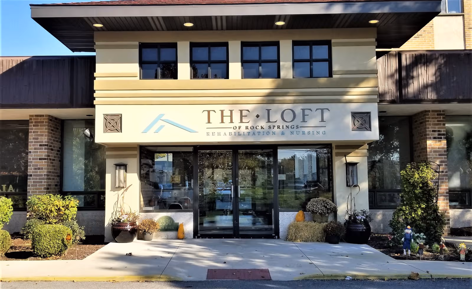 Front of The Loft Rehabilitation of Rock Springs with glass doors and landscaped entrance.