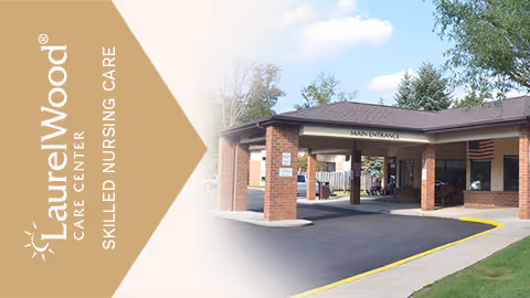 Front entrance of Amber Springs at Laurel Wood with brick building and covered drop-off.