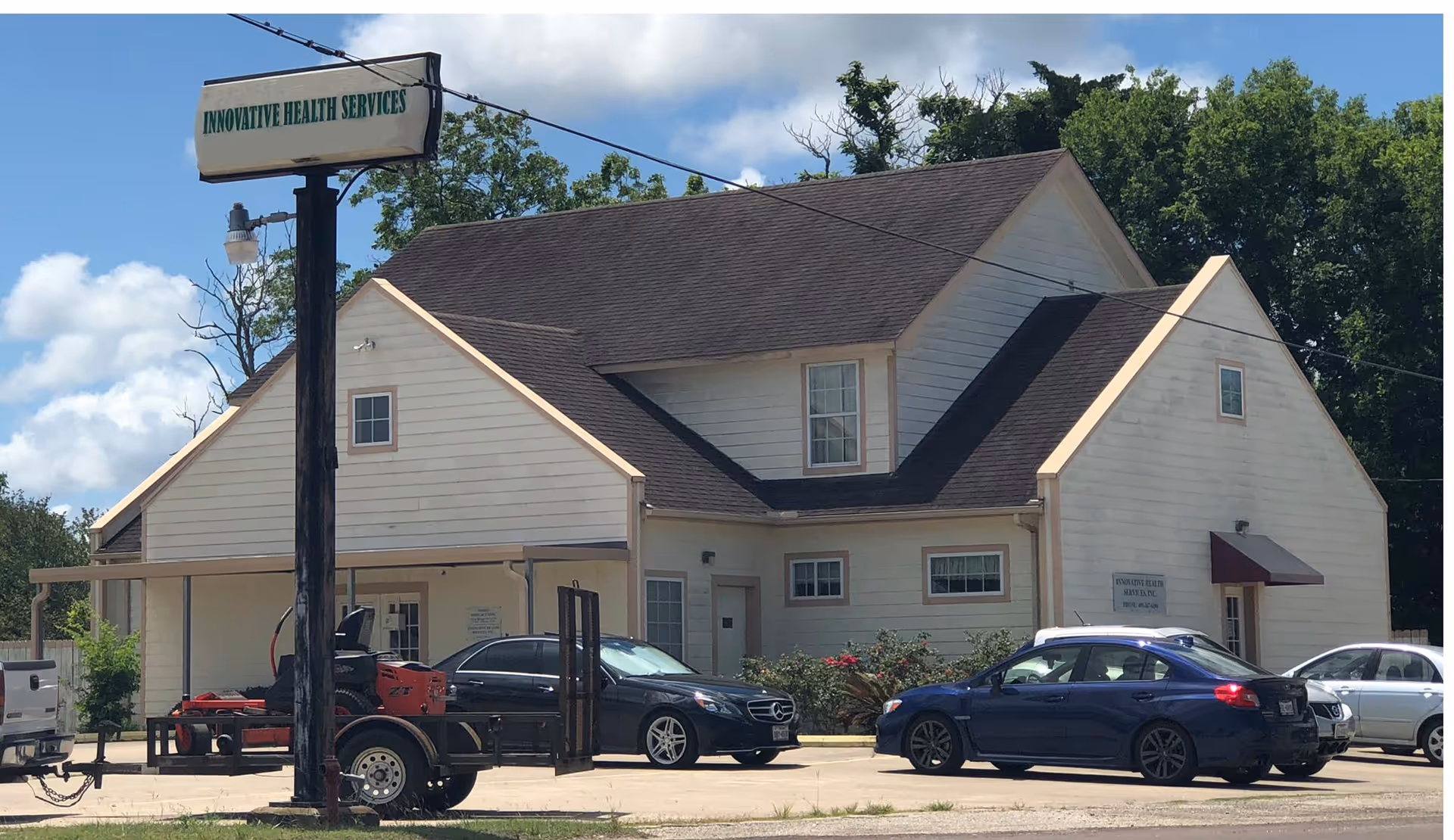 Beige building exterior with Innovative Health Services sign and several parked cars in front.