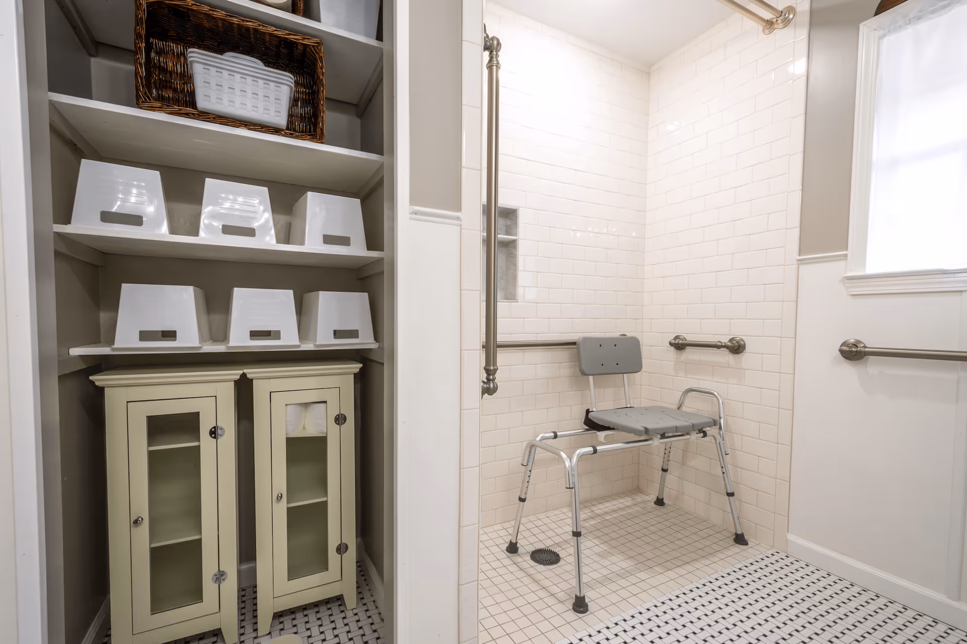 Accessible bathroom with a shower chair, grab bars, and storage cabinets