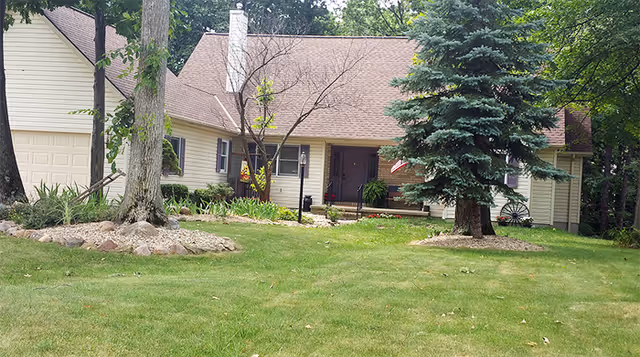 Gravette Manor Nursing Home exterior: a single-story building with a front lawn and trees.