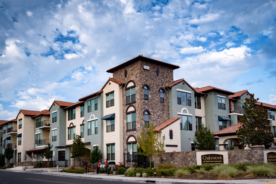 Oakmont of East Sacramento building exterior with stone facade and pastel walls