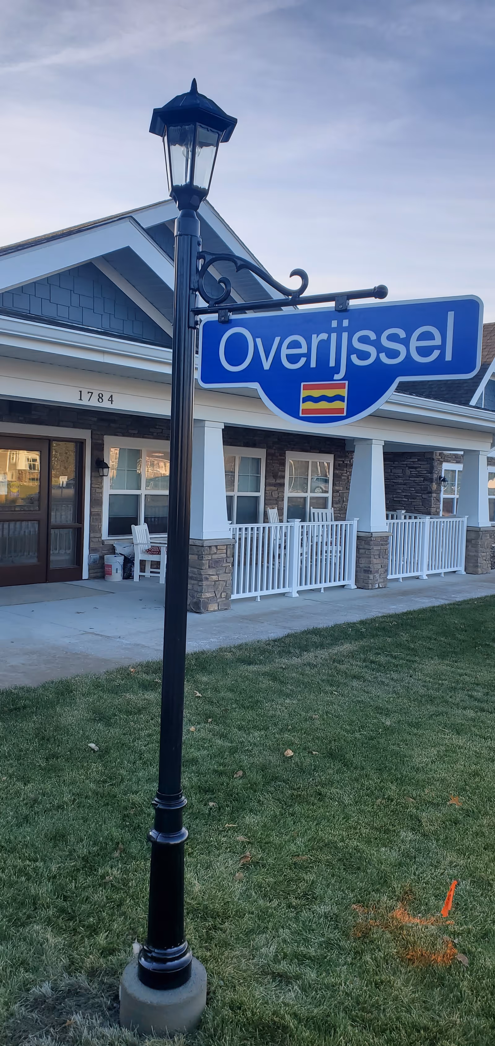 Exterior view of an Overijssel senior living facility with a blue sign.