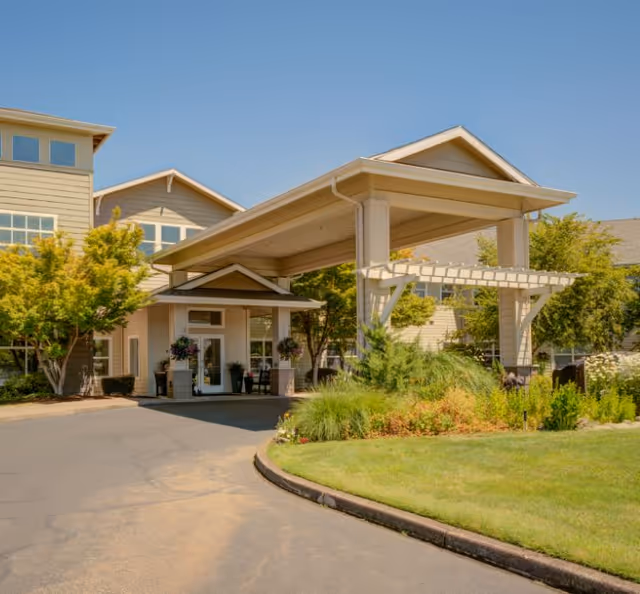 Evergreen Senior Living Eugene entrance with covered drop-off and landscaped front yard.