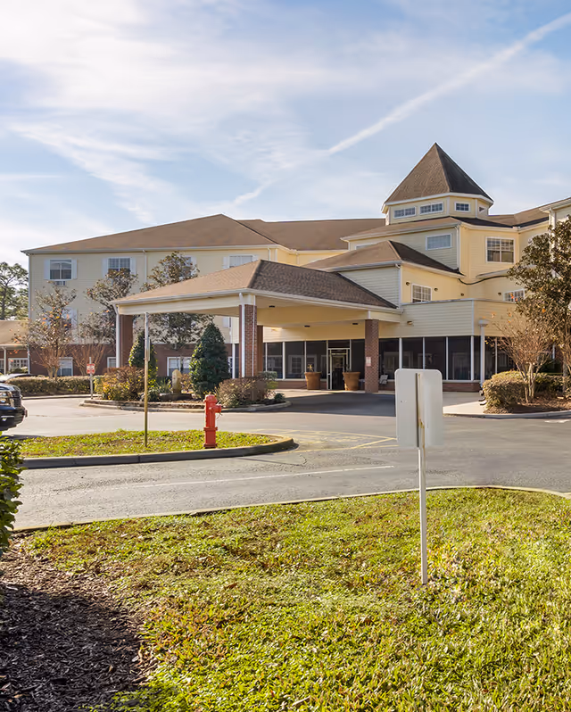 Exterior view of Brookdale Lake Mary building entrance with driveway and landscaping.