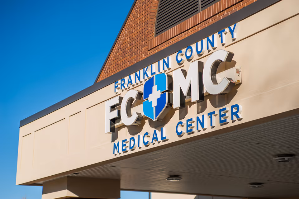 Front view of a medical center building with a large FCMC sign.