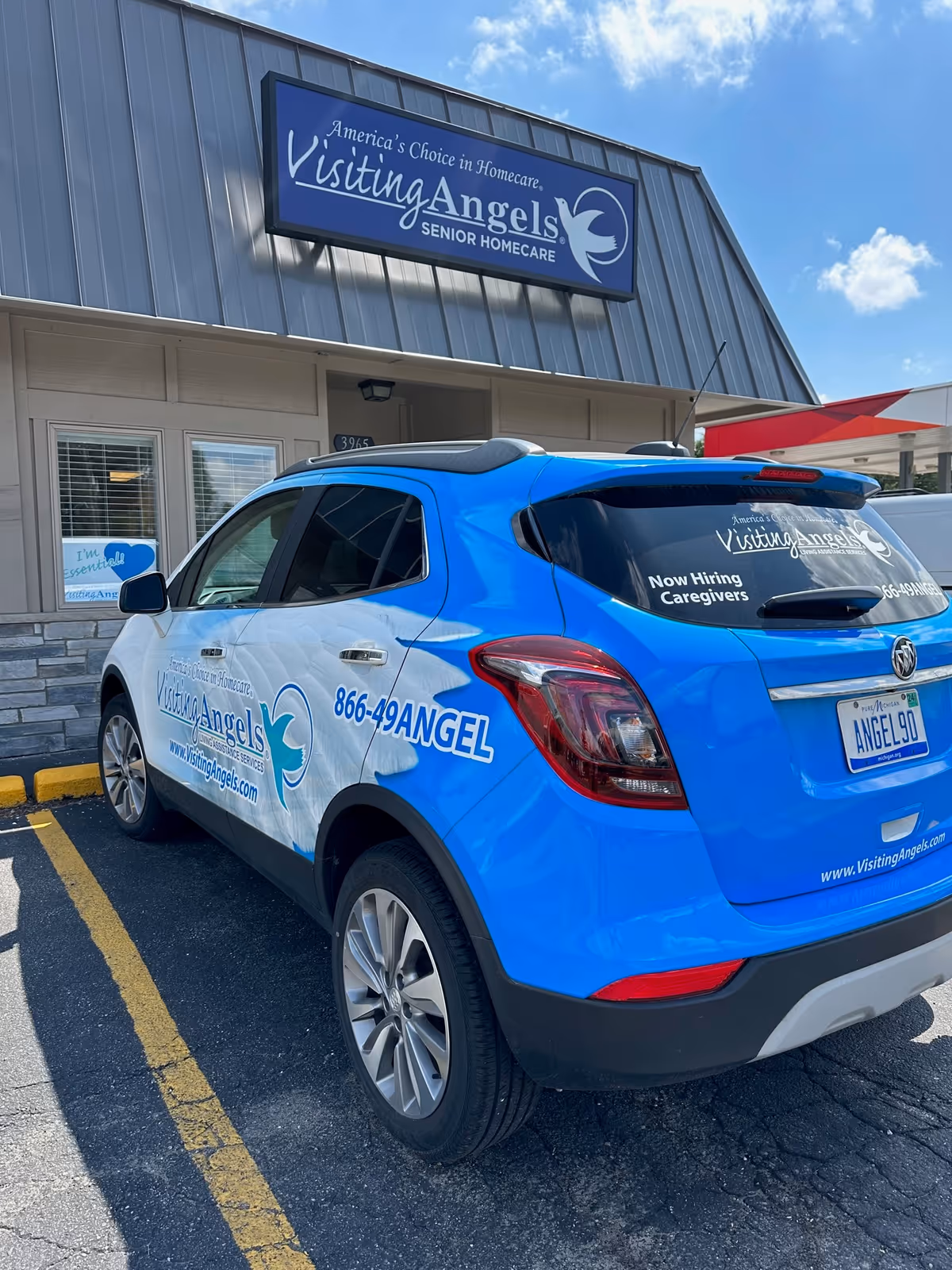 Exterior of Visiting Angels building with a blue company van parked in front.