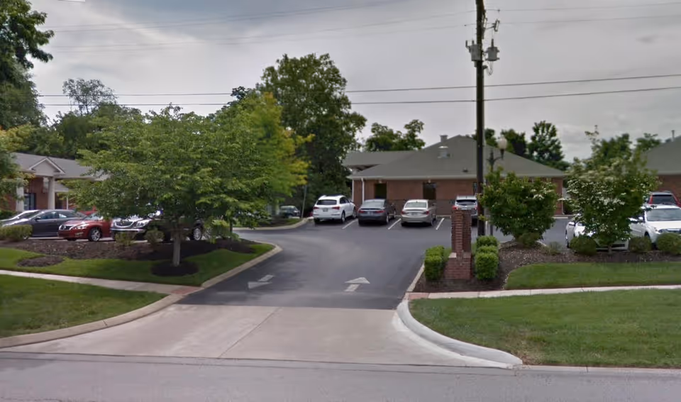 Exterior view of the Assisted Living Locators South Nashville facility with a driveway and parked cars.