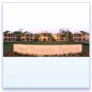 Exterior view of a senior living campus with a sign reading Grand Traverse Pavilions.