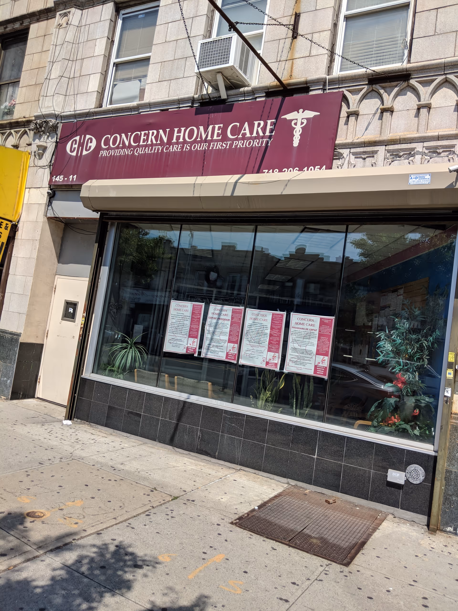 Storefront of Concern Home Care, Inc. with large windows, signage, and potted plants.