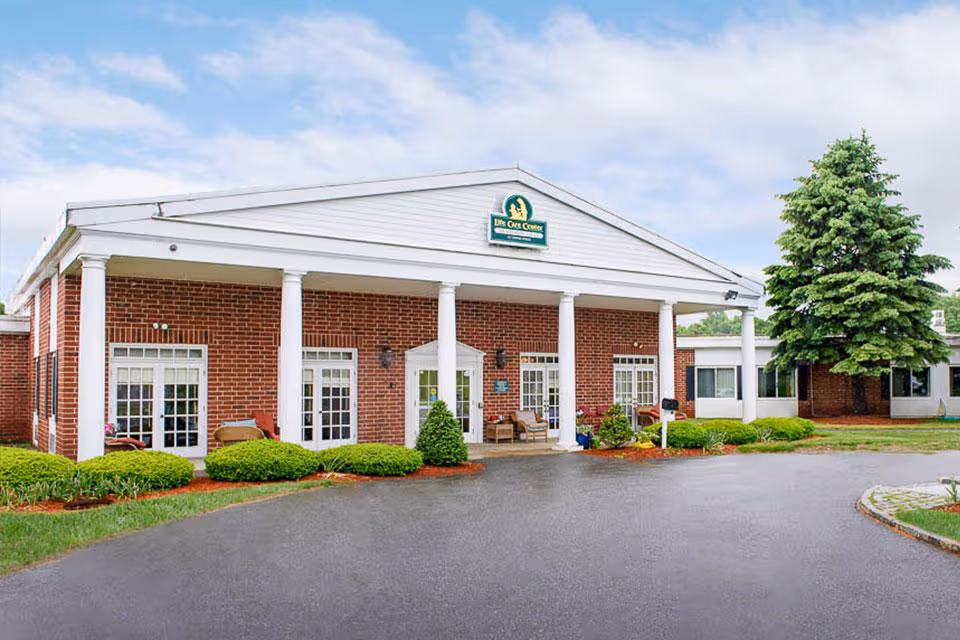 Brick Life Care Center front with white columns and a circular driveway.