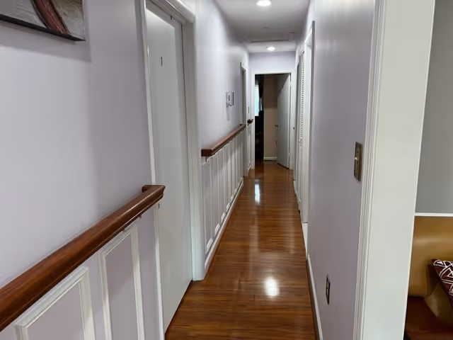 Interior hallway at Green Pasture Residences with wood floors and doors.