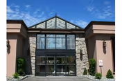 Front entrance of Desert Haven Care Center with stone facade and glass doors.