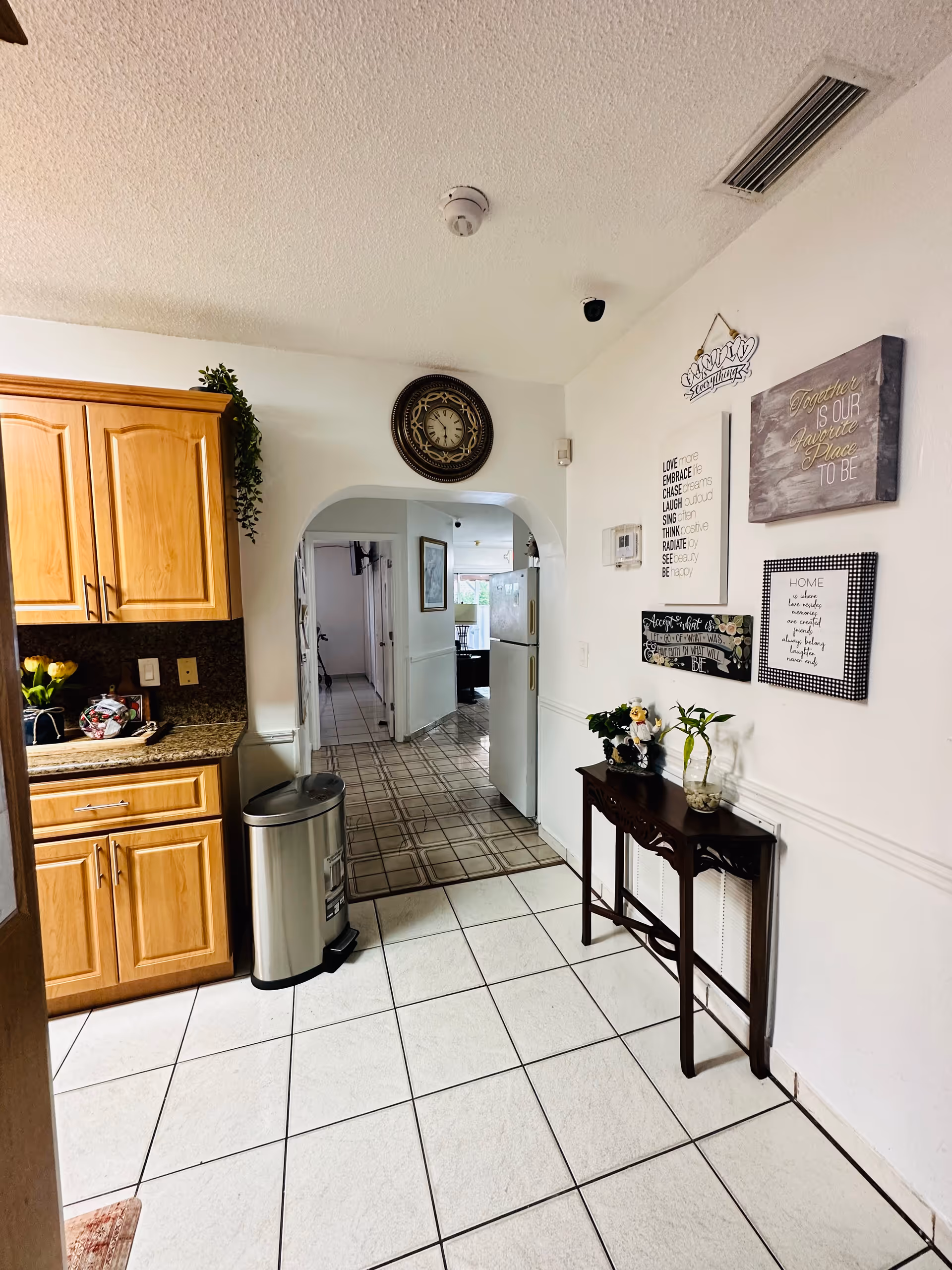 Paradise Adult Center interior: kitchen and hallway with cabinets and wall decor.