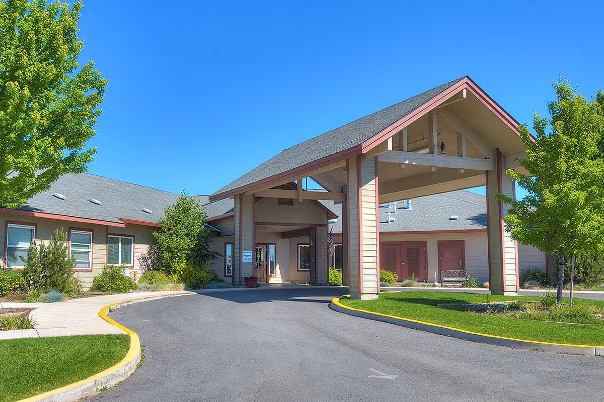 Exterior view of Eagle Lake Village with a covered entrance and landscaped driveway.