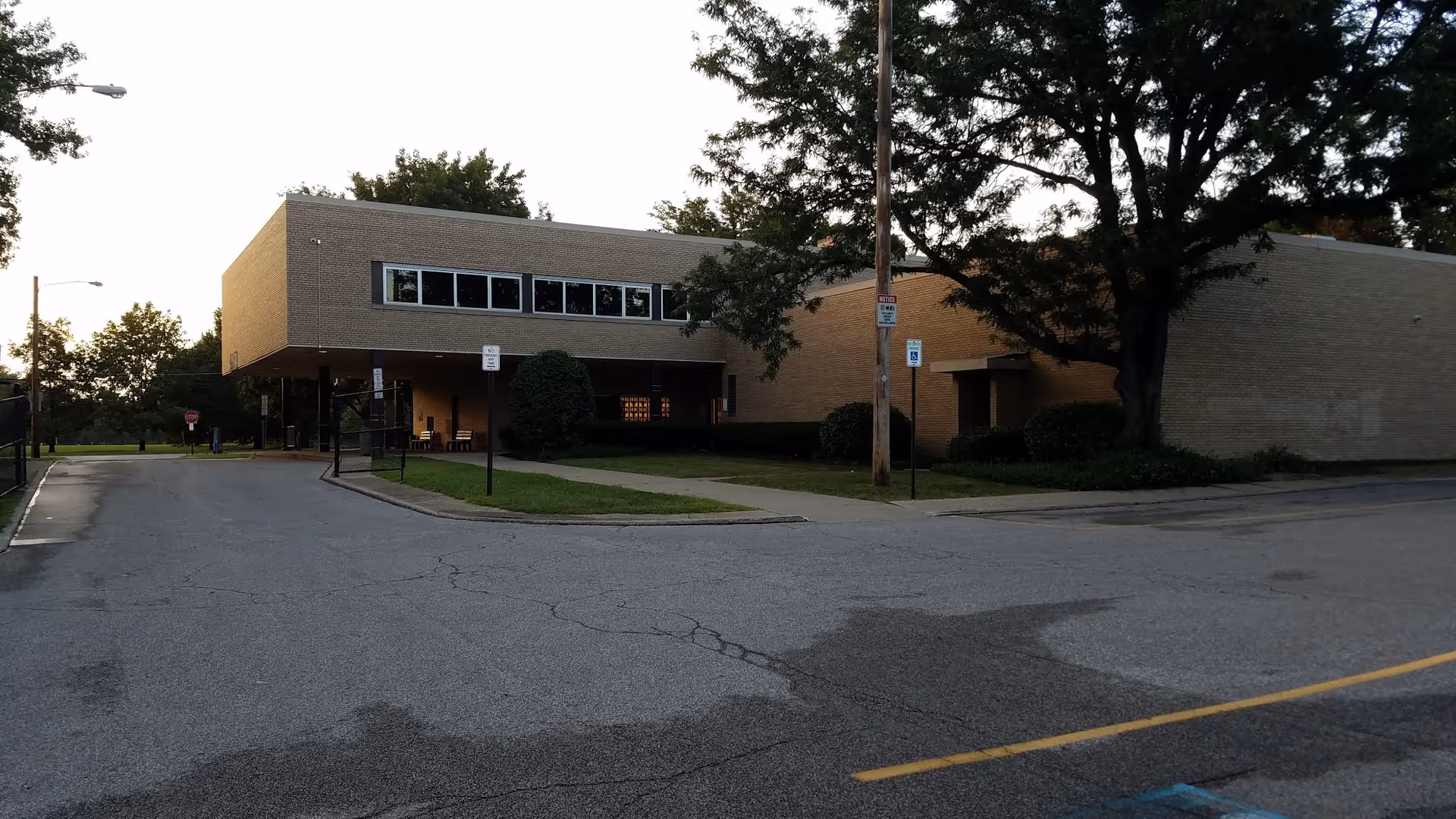 Exterior view of Glenville Health Center building with parking and trees.