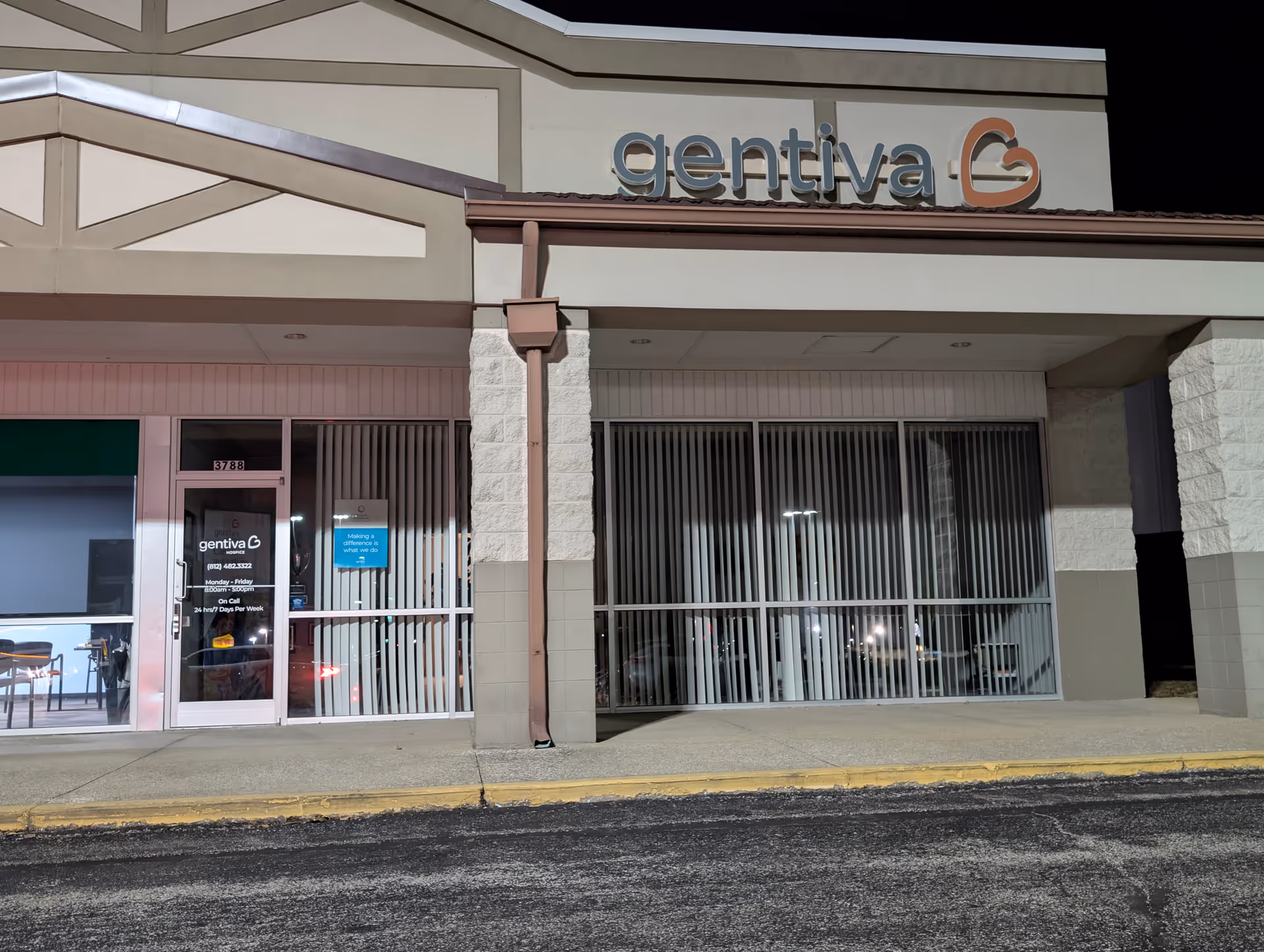 Front exterior of Gentiva Hospice building with glass entry, vertical blinds, and signage.