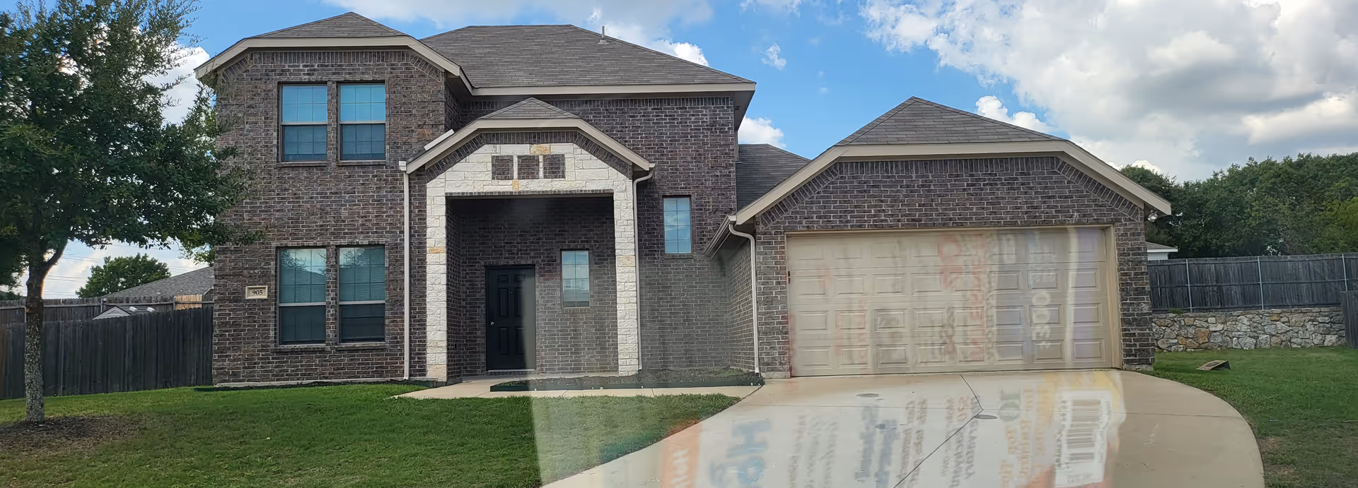 Front view of a brick senior living facility with attached garage.
