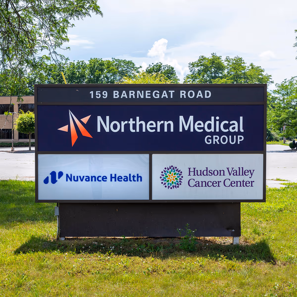 An outdoor sign displays Northern Medical Group logo with Nuvance Health and Hudson Valley Cancer Center.