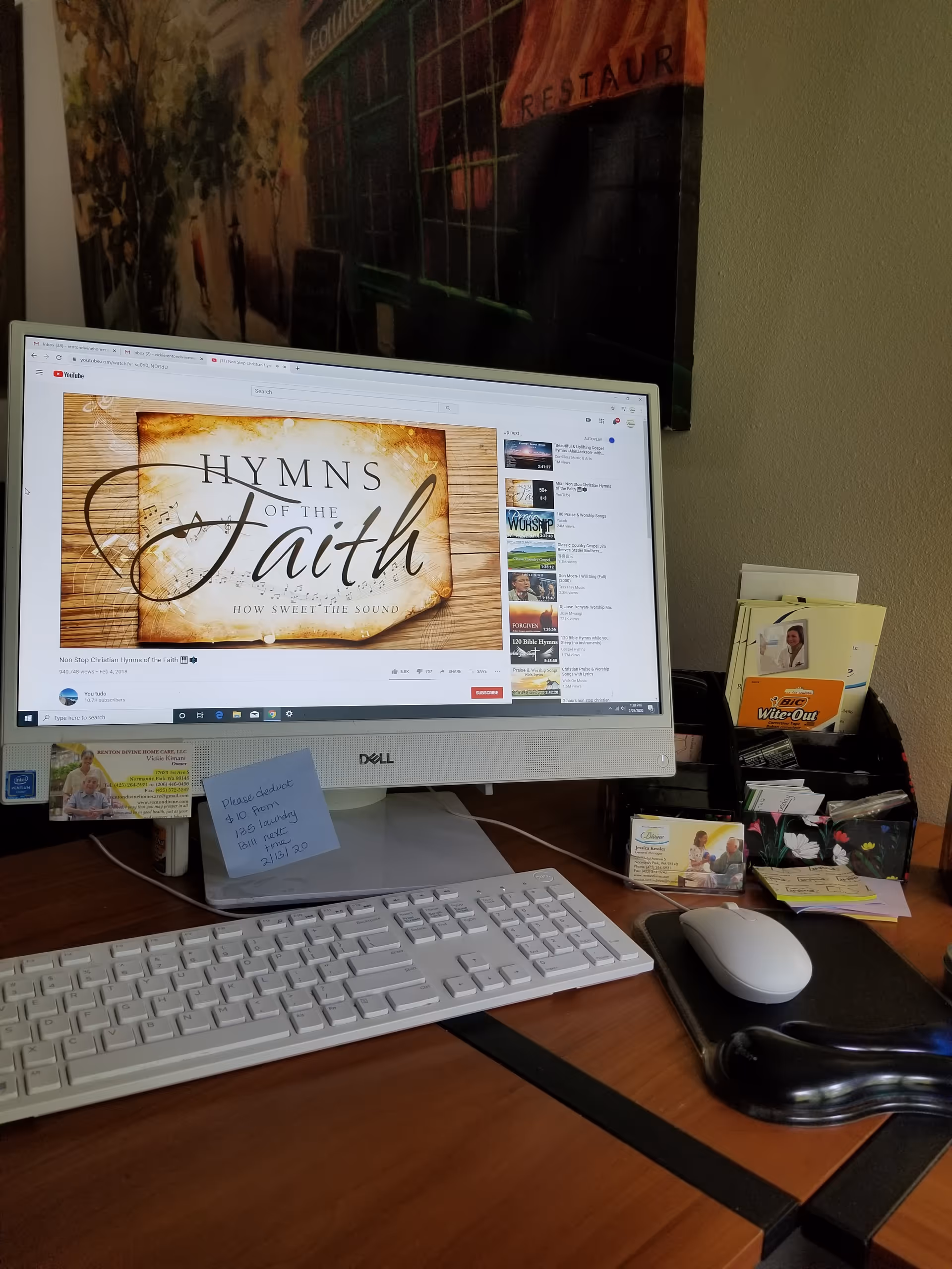 Office desk with Dell monitor, keyboard, mouse, and business cards.