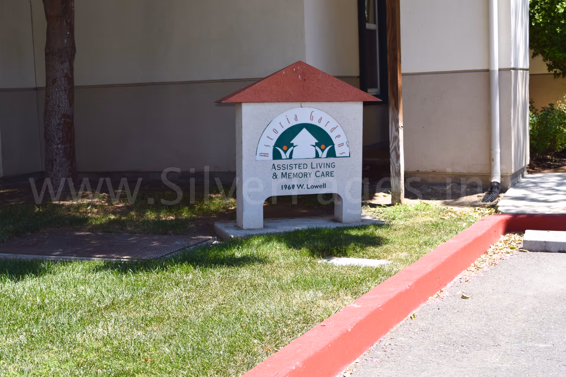 Exterior view of a senior living facility entrance sign with logo