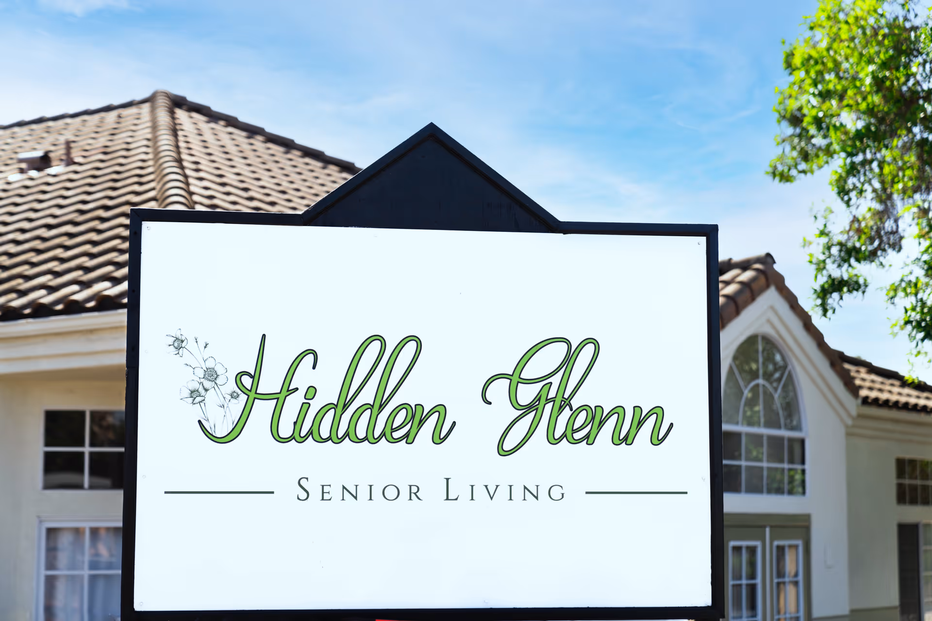 A large sign reads Hidden Glenn Senior Living in front of a building.