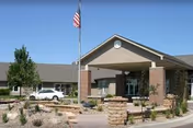 Front exterior of Bethany Home Sioux Falls showing entrance, flagpole, brick columns, and landscaping.