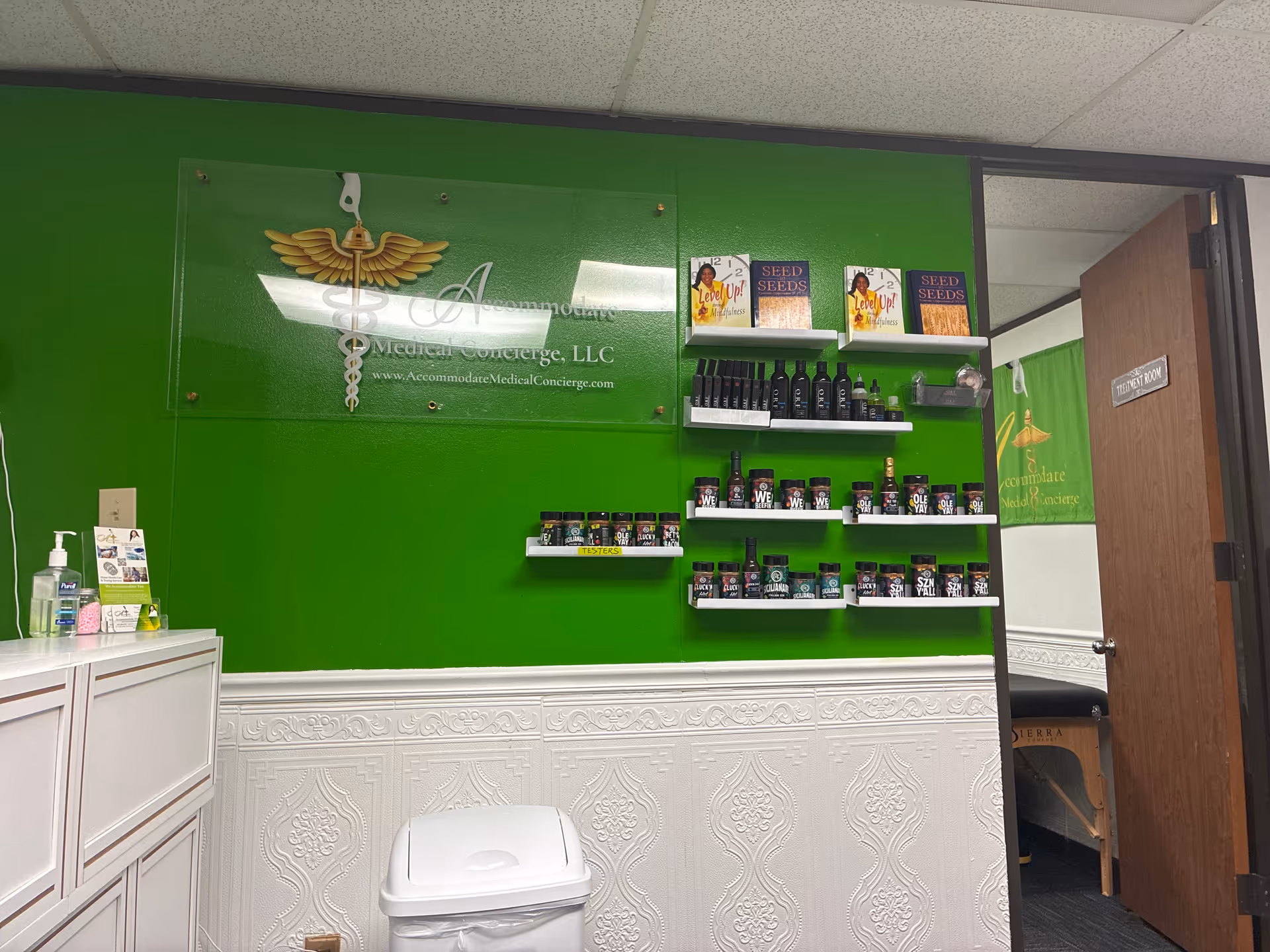 Bright green wall with product shelves and ornate white wainscoting in a reception area.