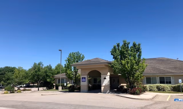 Exterior view of The Cottages at Columbia Village entrance with a covered portico.