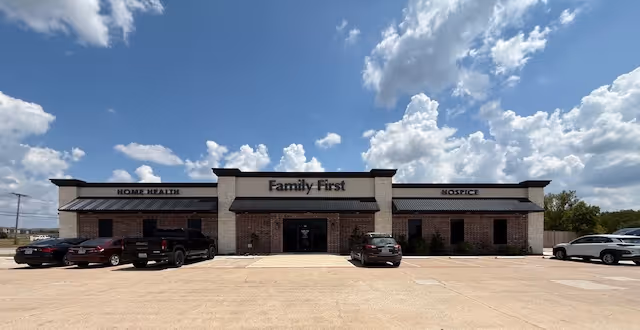 Front view of a single-story Family First facility with a large parking lot.