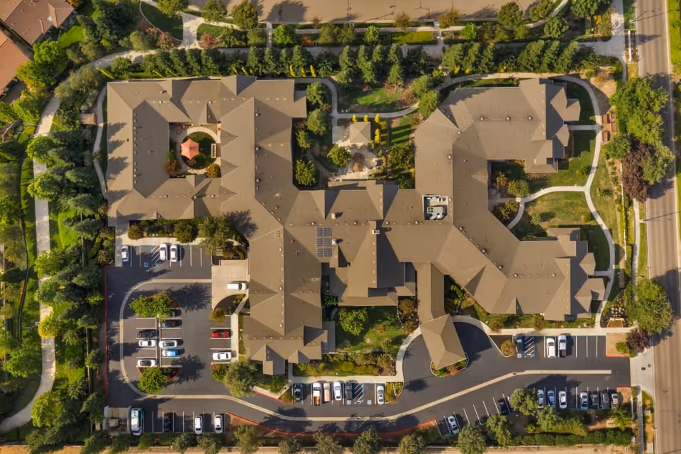 Aerial view of The Commons at Union Ranch showing the building complex, parking lots, walkways, and landscaped grounds.