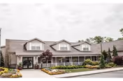 Front view of Morristown Manor senior living facility with landscaped entrance and parking