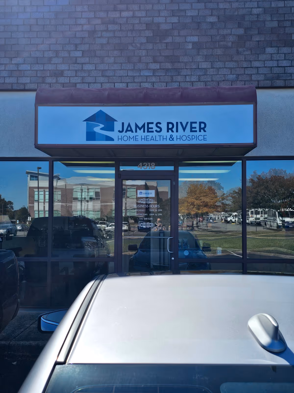 Front view of James River Home Health and Hospice storefront with glass doors.