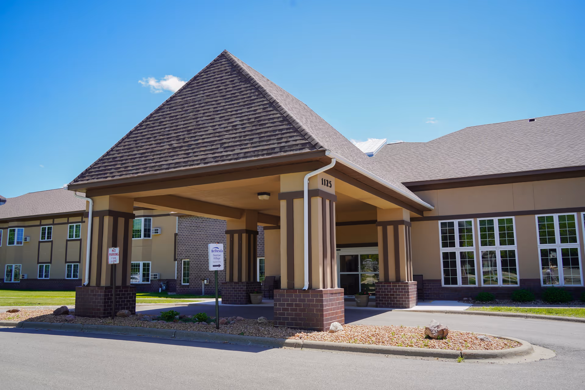 Bethesda Assisted Living exterior with a covered entrance and large windows.