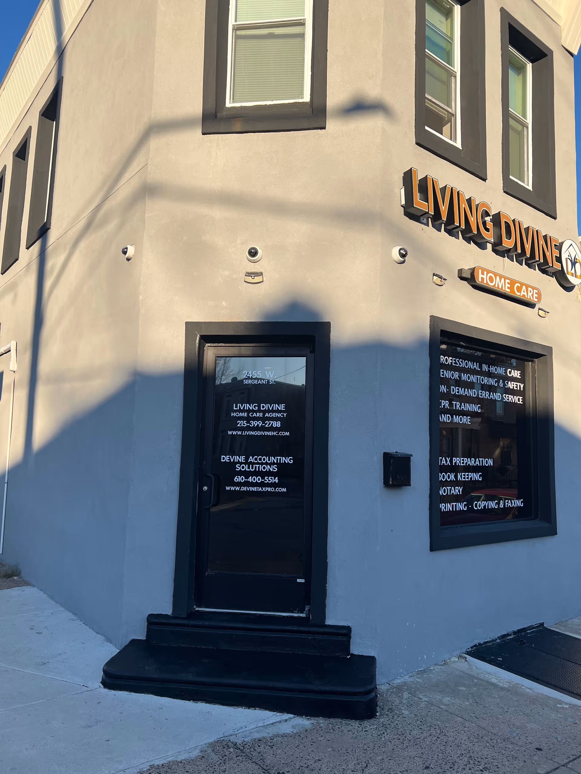Exterior corner of a building with Living Divine Home Care signage and entrance door.