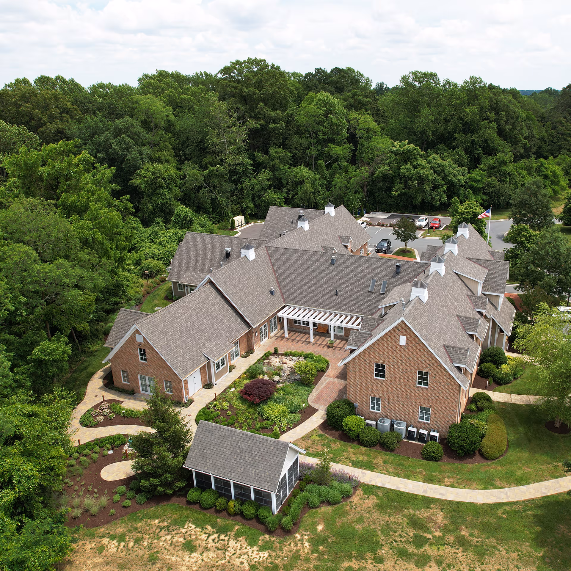 Aerial view of Compass senior living campus surrounded by trees and landscaped walkways.