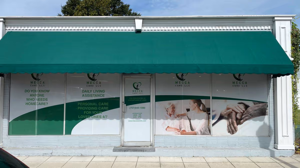 Storefront with green awning, large windows, and Mecca Care LLC signage.