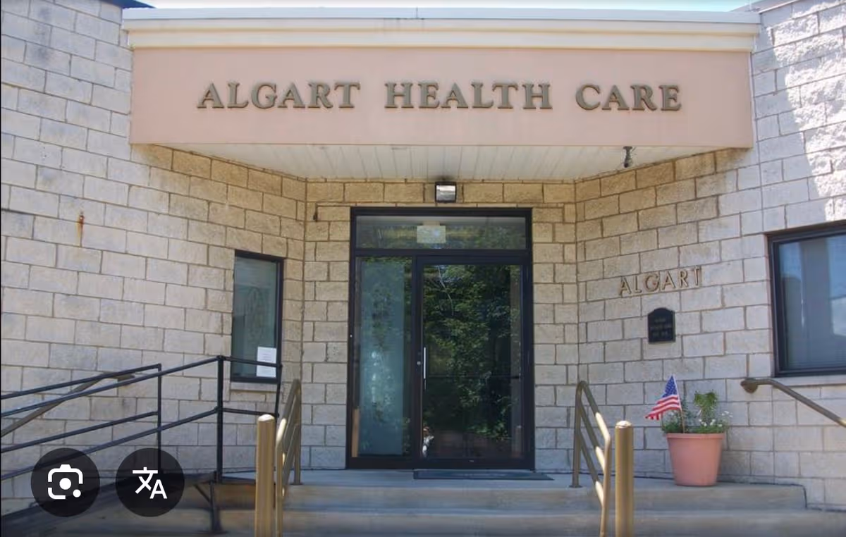 Exterior entrance of Algart Health Care with stone walls, steps, and ramp.