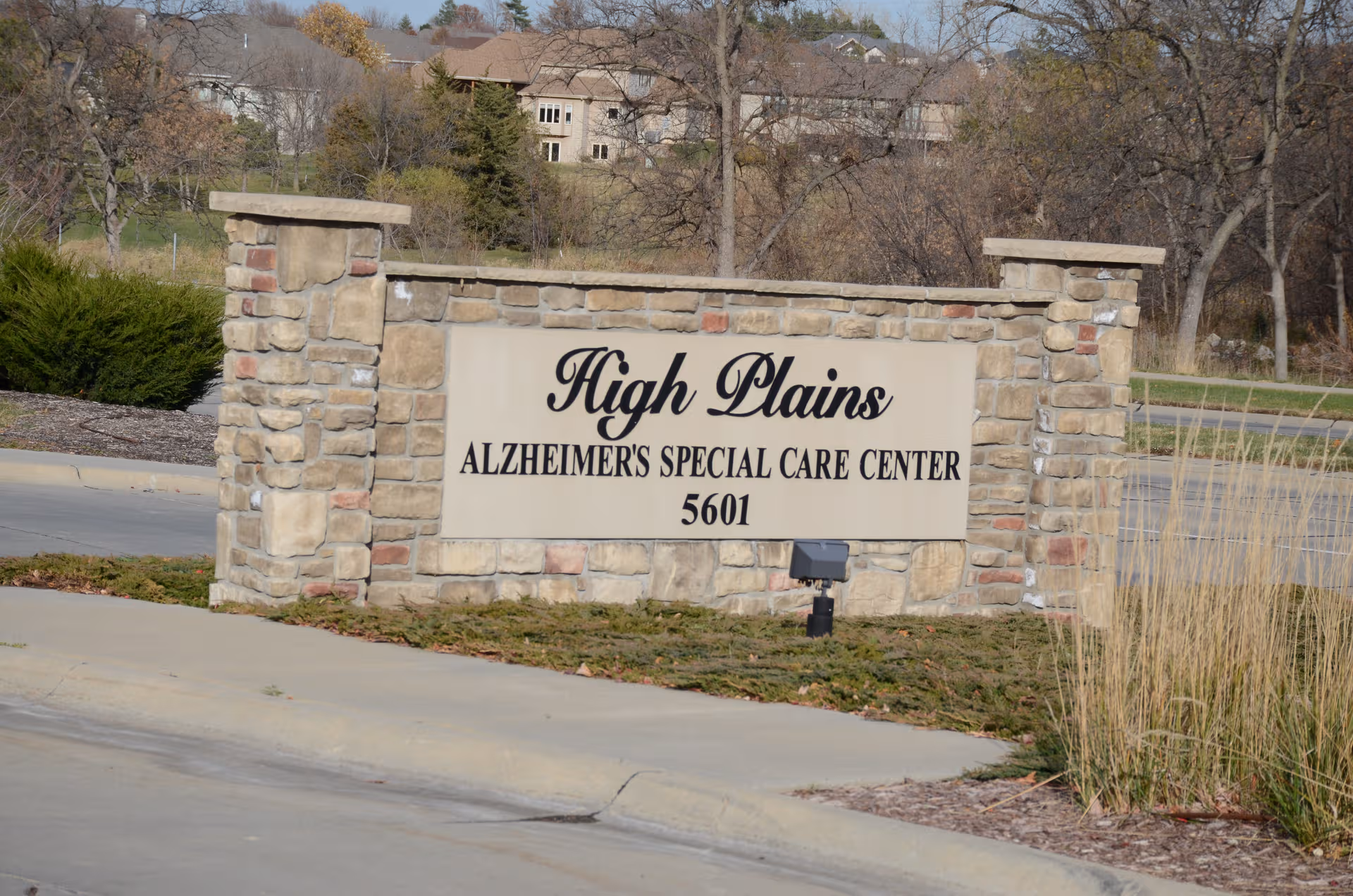 Stone entrance sign for High Plains Alzheimer's Special Care Center with address 5601.