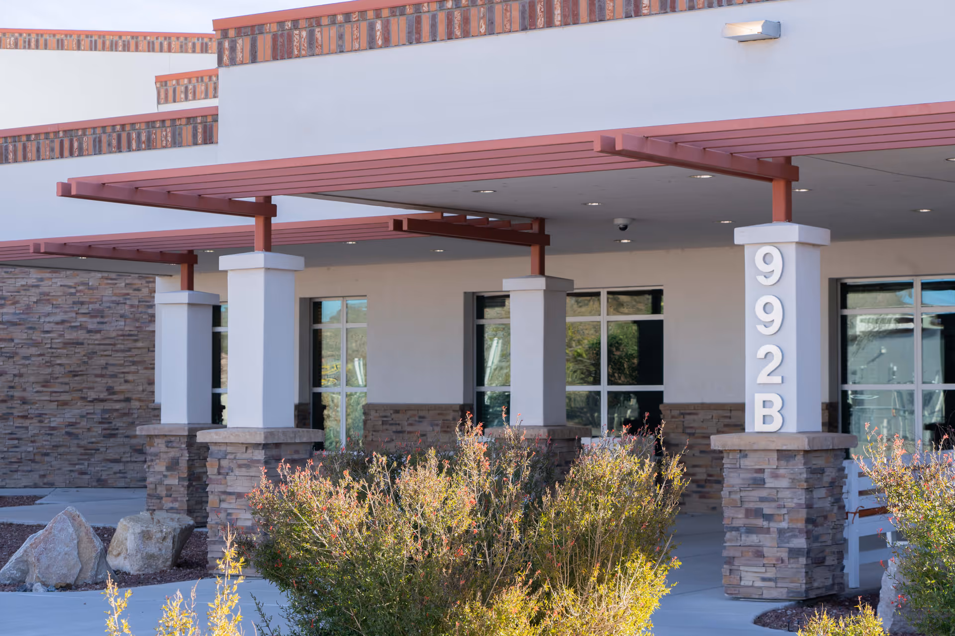 Exterior of New Mexico State Veterans Home with a covered entrance and stone columns.