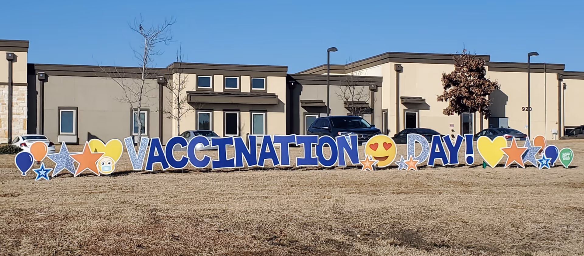 Exterior view of The Heritage at Twin Creeks with a large vaccination day sign.