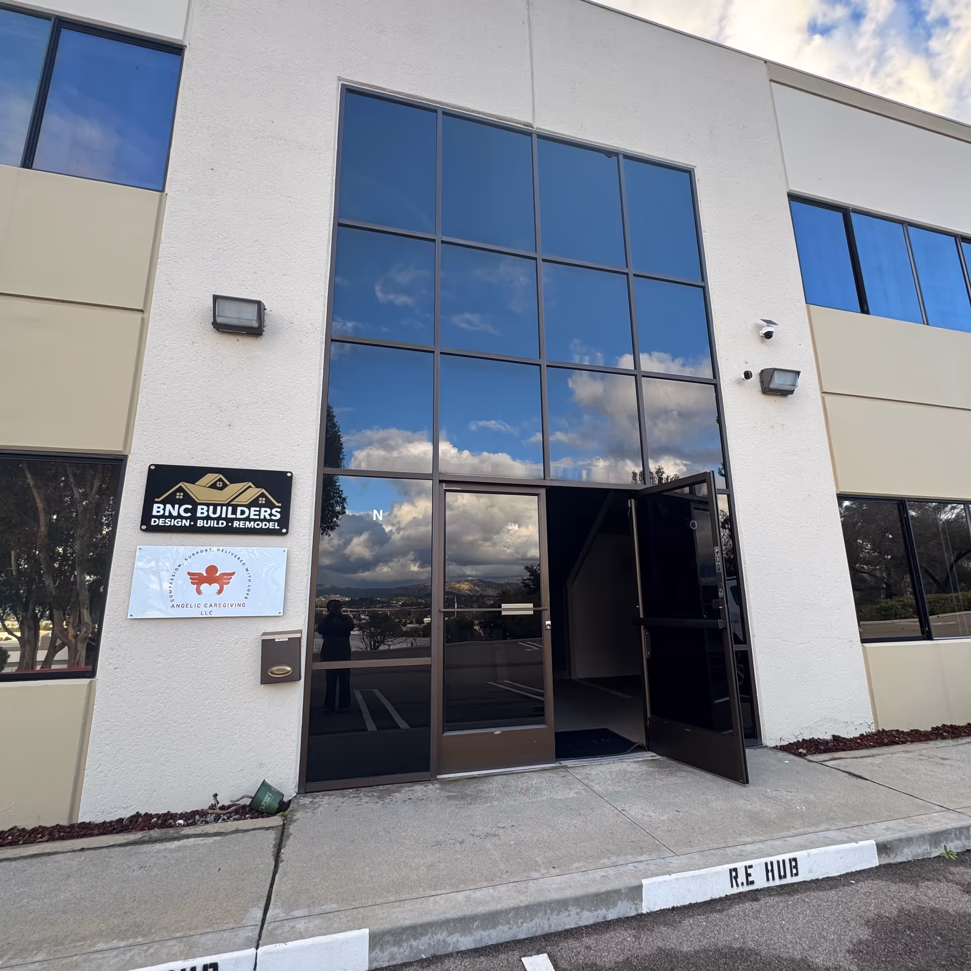 Front entrance of Angelic Caregiving LLC building with large glass windows.