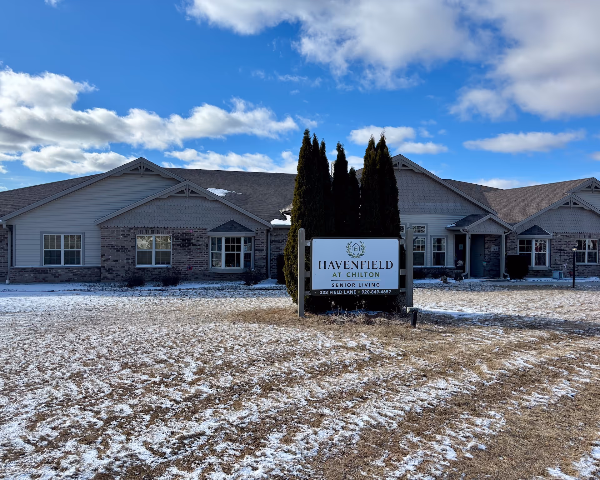 A single-story senior living facility exterior with a centered sign reading Havenfield at Chilton.