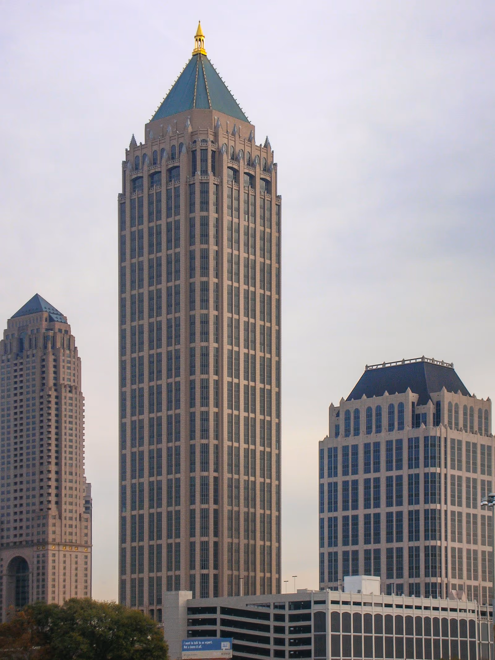 City skyscrapers rise against a pale sky, with a prominent central tower.