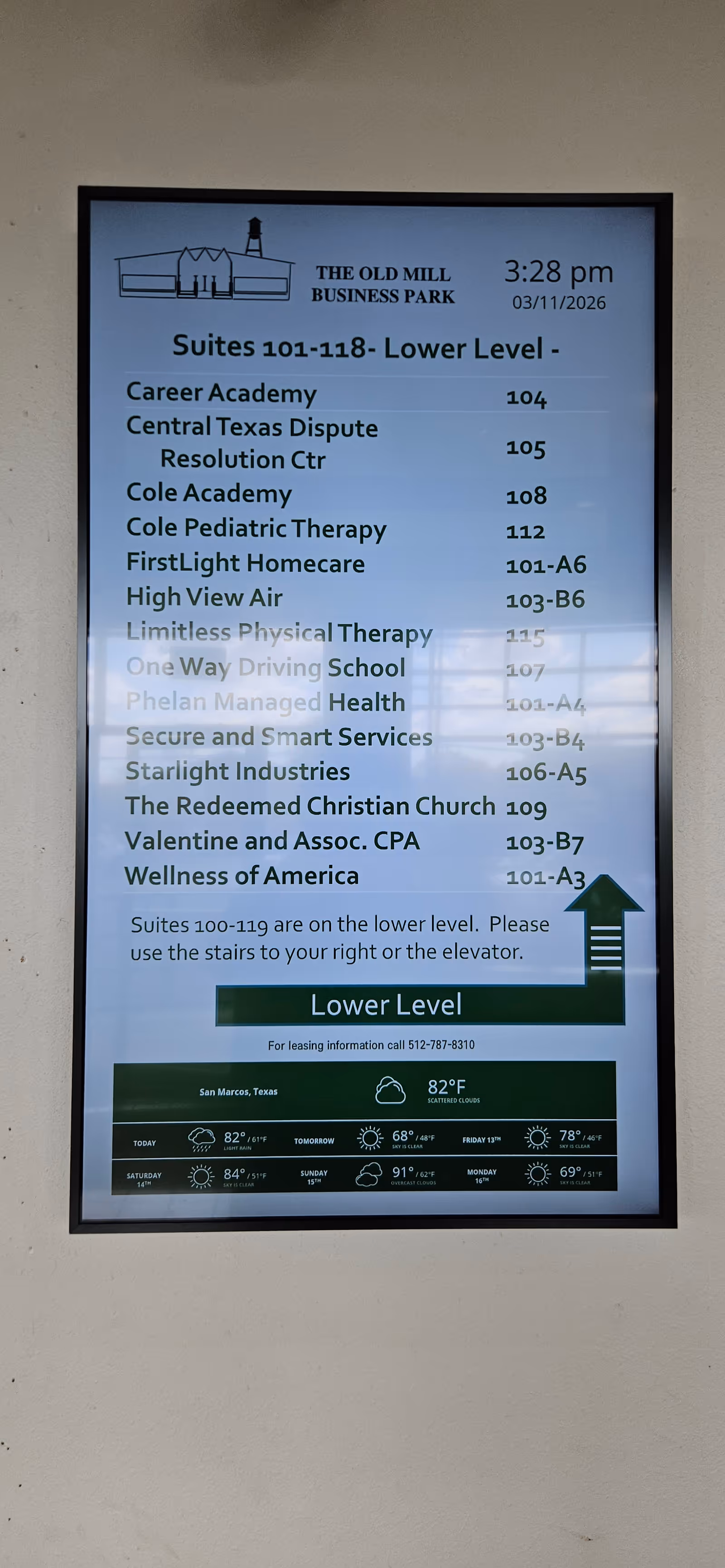 Directory sign on wall listing tenants, including FirstLight Home Care of Kyle, Old Mill Business Park.
