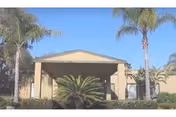 Front entrance of Fairway Oaks Center with palm trees and a covered portico.