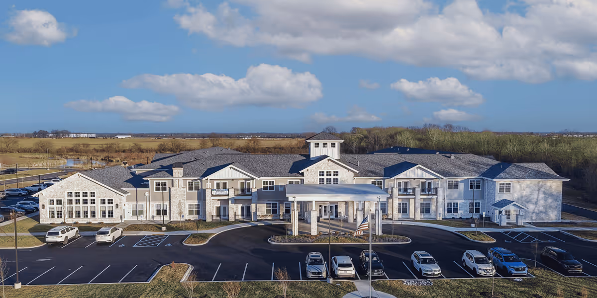A large senior living facility exterior with multiple wings and a front entrance.
