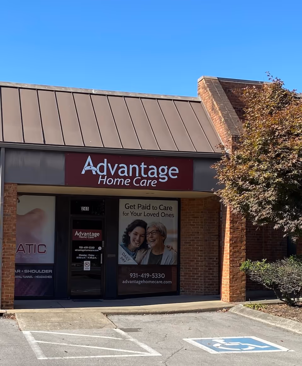Front of Advantage Home Care building with sign, glass doors, and brick exterior.