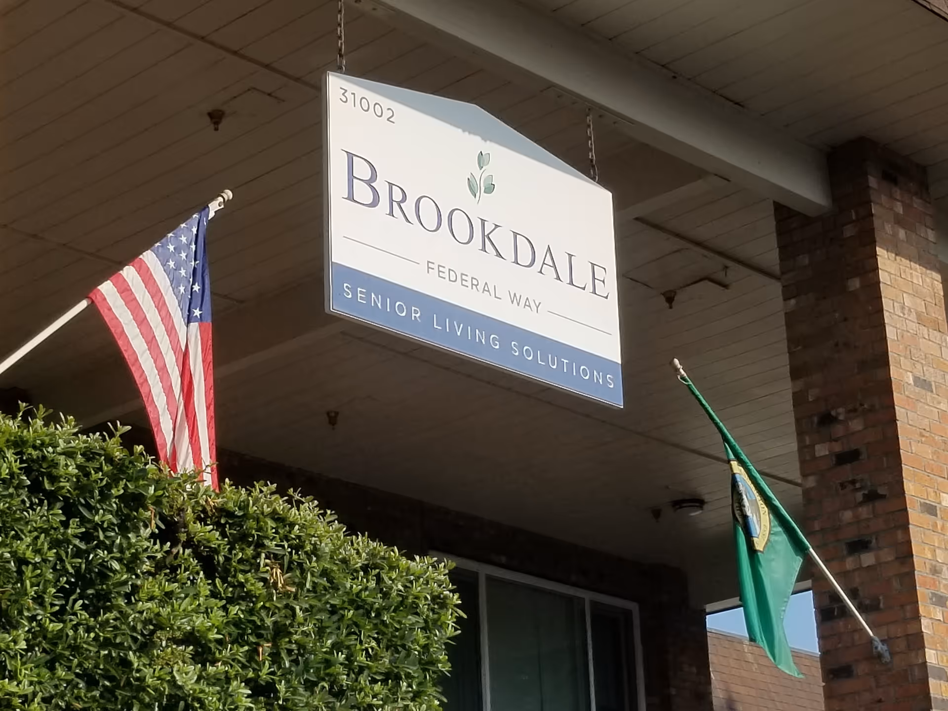 Exterior view of Brookdale Federal Way facility entrance with signs and flags.